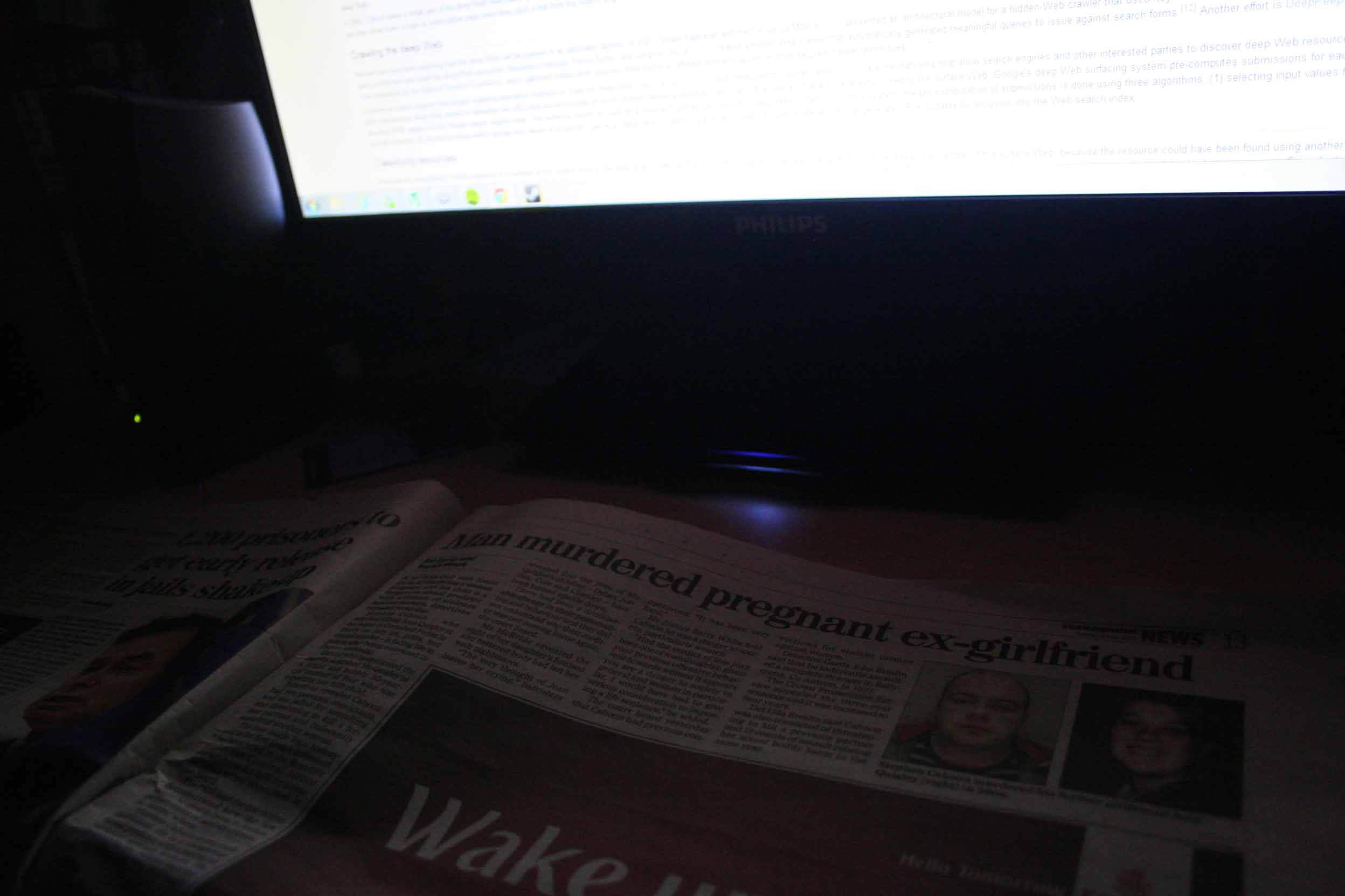 A paper beside a monitor