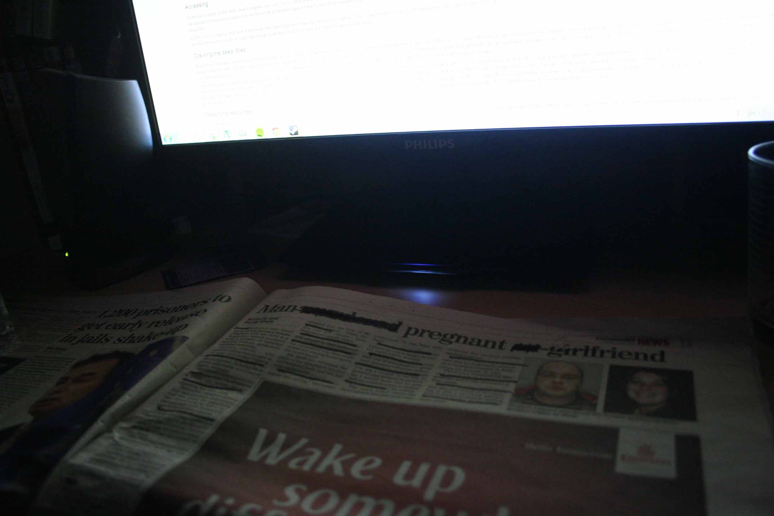A censored paper beside a monitor